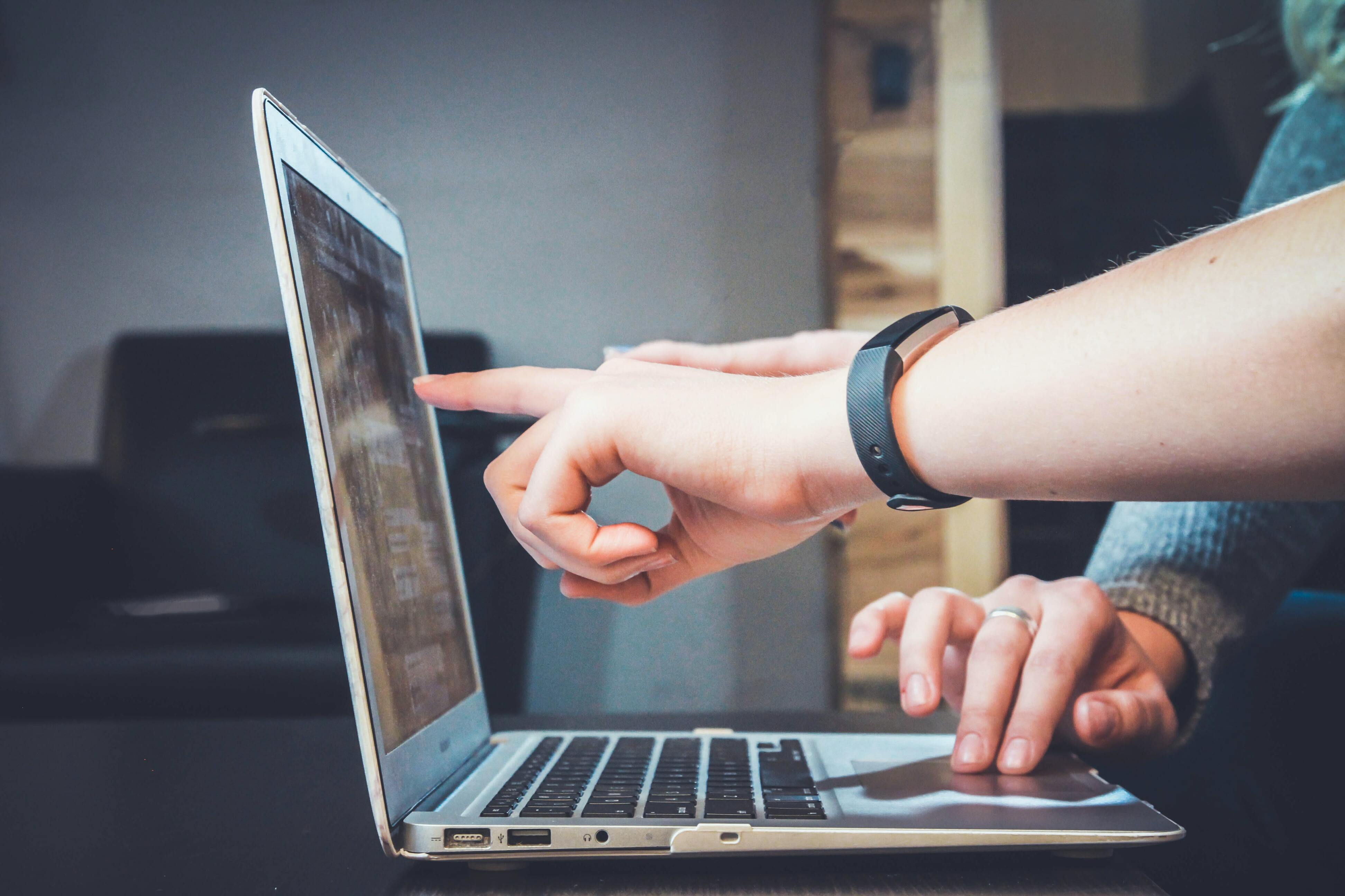 Person pointing to a computer screen