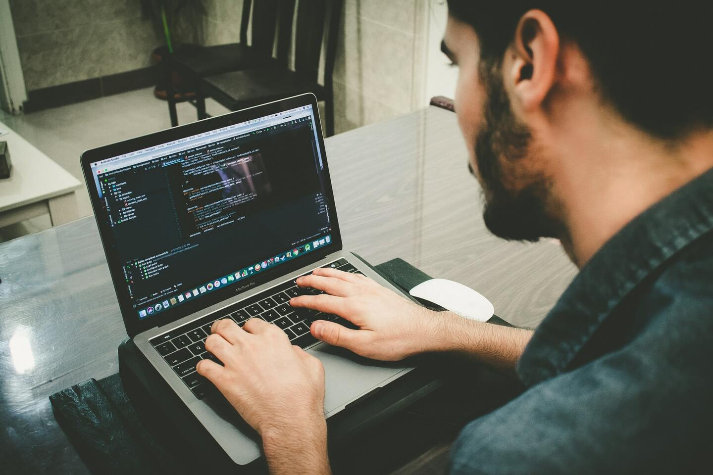 man coding with a laptop